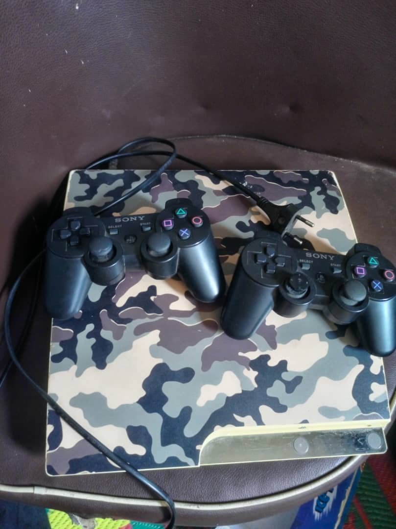 PlayStation 3 Slim with 2 Controllers Sony PS3 Slim in a camouflage skin, complete with two original Sony wireless controllers and power cable. Ready to plug in and play. Price: UGX 350,000